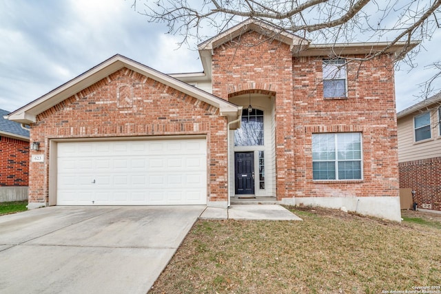 front of property featuring a garage and a front lawn