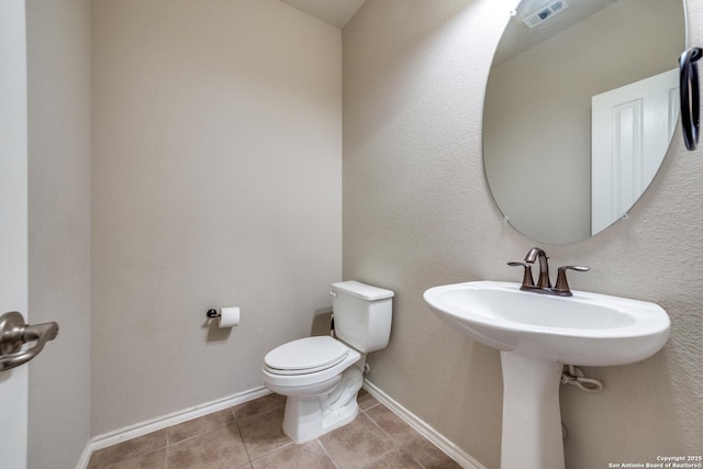 bathroom featuring tile patterned floors and toilet