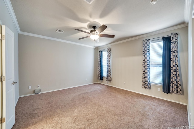 carpeted spare room featuring ceiling fan and ornamental molding