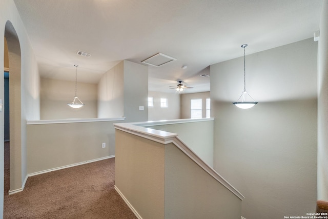 hall featuring carpet flooring