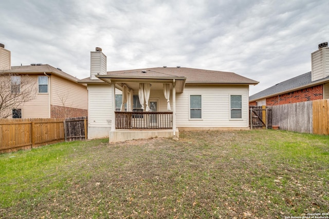 rear view of house with a lawn