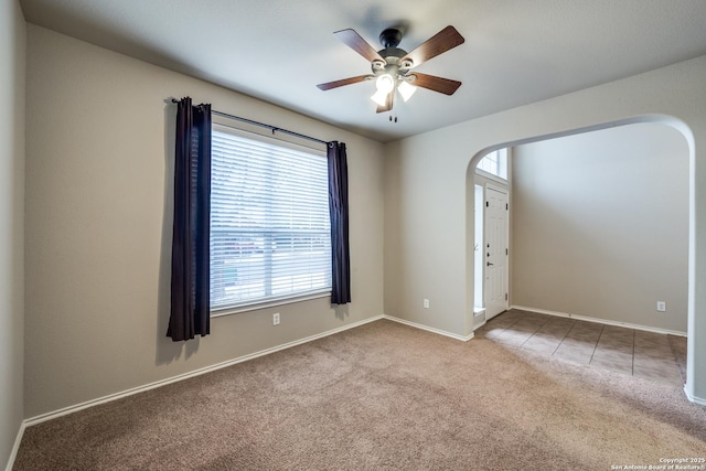 carpeted empty room with ceiling fan