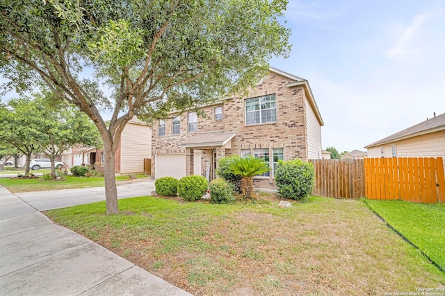 view of front of property with a garage and a front lawn