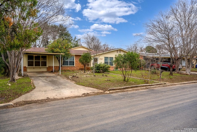 single story home with a carport and a front lawn