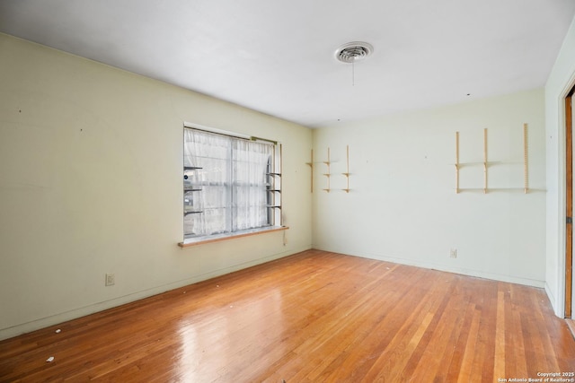 unfurnished room with light hardwood / wood-style floors