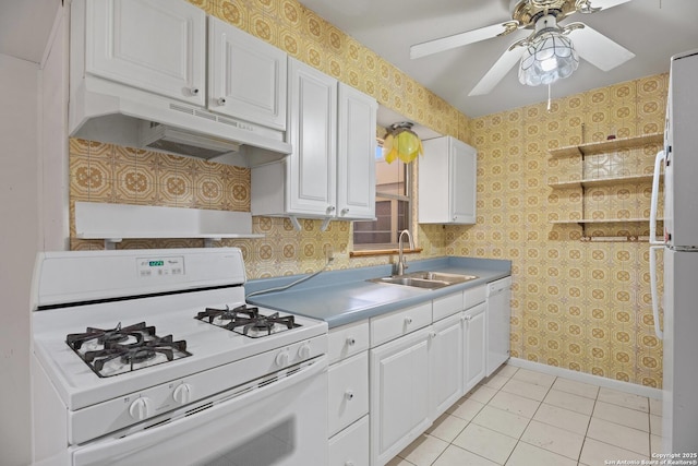 kitchen featuring white cabinetry, sink, light tile patterned floors, and white appliances