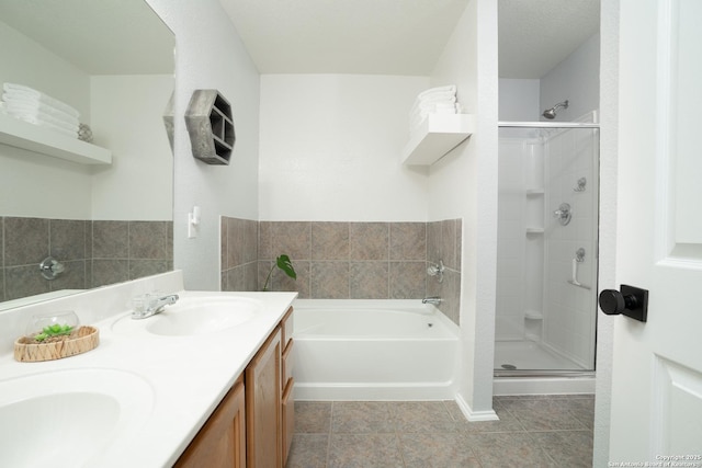 bathroom with independent shower and bath, vanity, and tile patterned floors