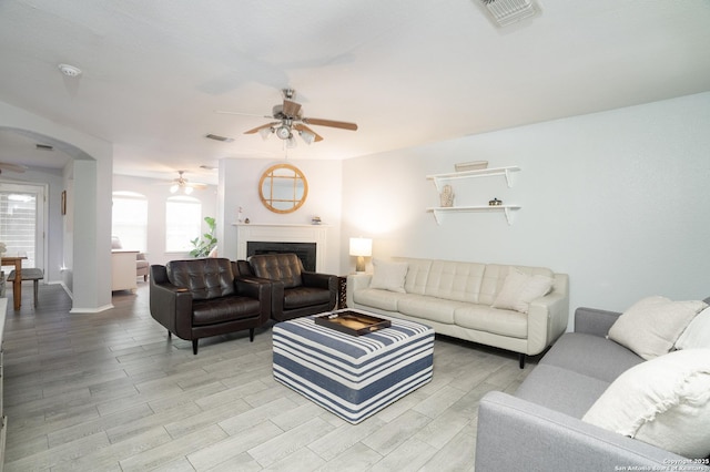 living room with ceiling fan and light hardwood / wood-style floors