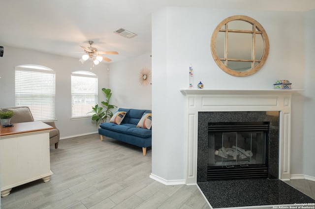 living room featuring light hardwood / wood-style flooring and ceiling fan