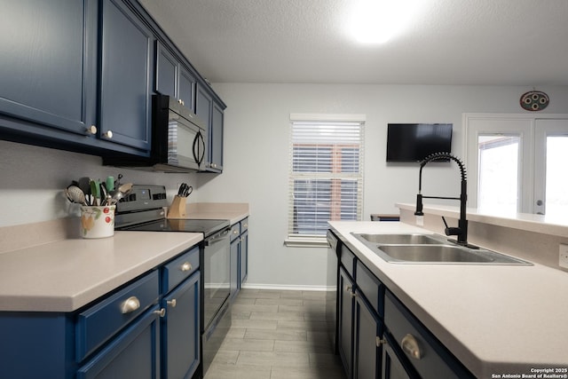 kitchen featuring blue cabinets, sink, a textured ceiling, and black appliances