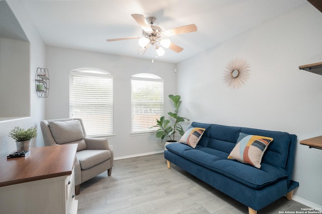 living room featuring ceiling fan and light hardwood / wood-style flooring