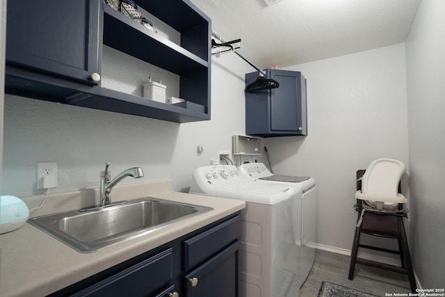 washroom with cabinets, sink, hardwood / wood-style floors, and washing machine and clothes dryer