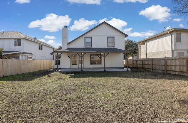 back of property with a patio and a lawn