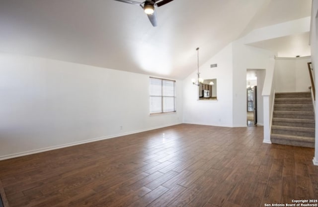 unfurnished living room featuring dark wood-type flooring, lofted ceiling, and ceiling fan with notable chandelier