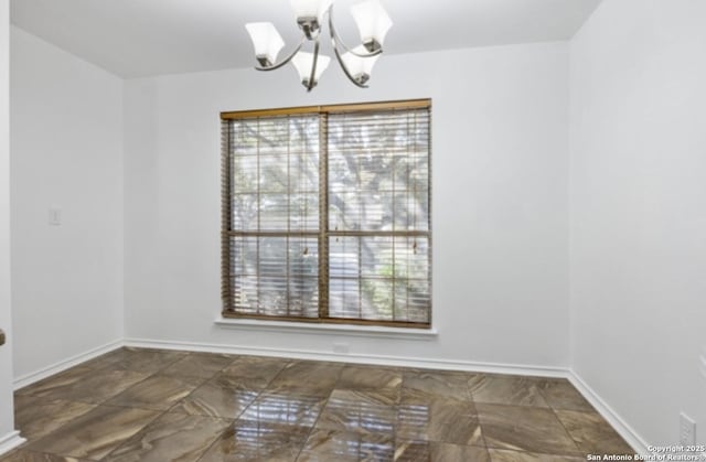 unfurnished dining area featuring a healthy amount of sunlight and a chandelier