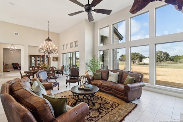 living room with light tile patterned flooring and ceiling fan with notable chandelier