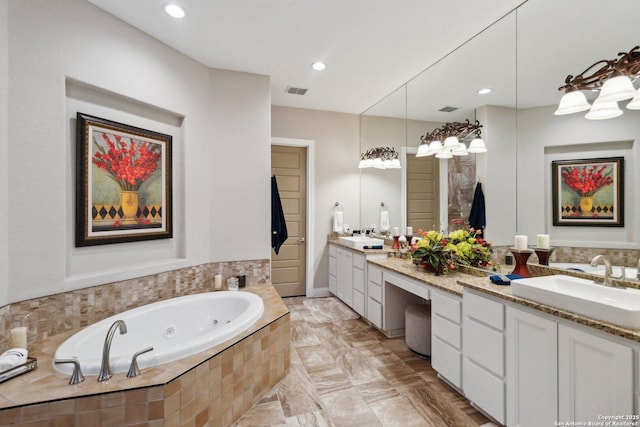 bathroom featuring vanity and a relaxing tiled tub