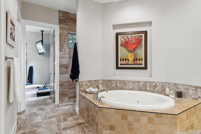 bathroom featuring tiled tub