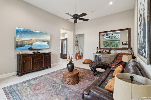 living room featuring light tile patterned flooring, wine cooler, bar area, and ceiling fan