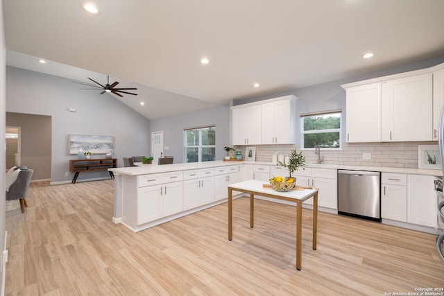 kitchen featuring dishwasher, sink, white cabinets, decorative backsplash, and light hardwood / wood-style flooring