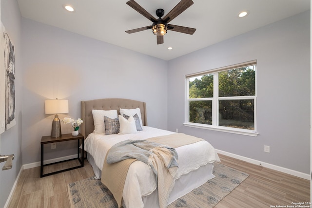 bedroom with hardwood / wood-style flooring and ceiling fan