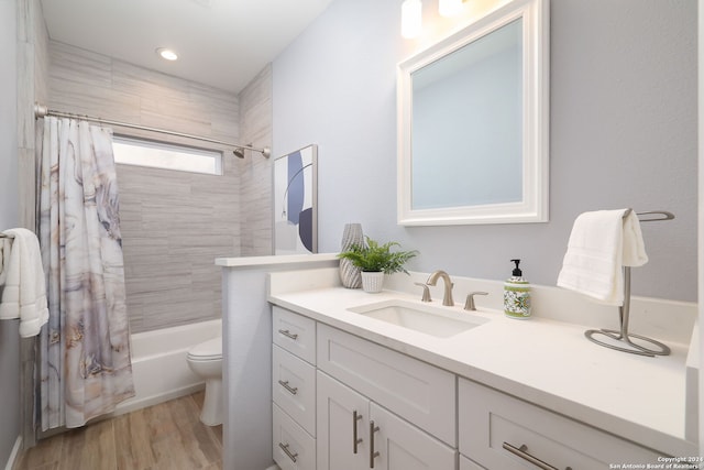 full bathroom with vanity, toilet, shower / tub combo, and wood-type flooring