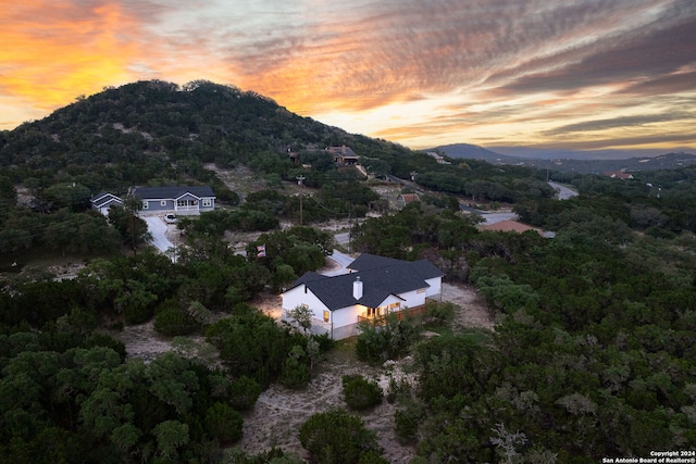 aerial view at dusk featuring a mountain view