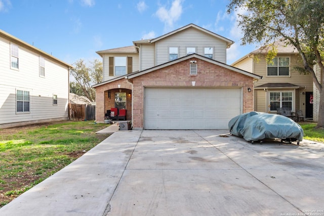 traditional-style home featuring a garage, brick siding, driveway, and fence