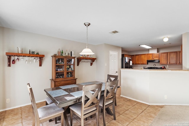 dining room with light tile patterned floors, baseboards, and visible vents