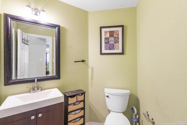 half bath with vanity and toilet