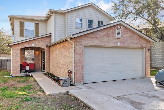 view of front of home featuring brick siding and driveway