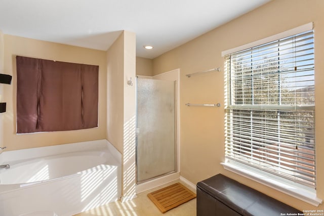 full bathroom with a stall shower, recessed lighting, baseboards, and a bath