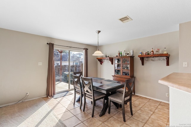 dining space with baseboards and visible vents