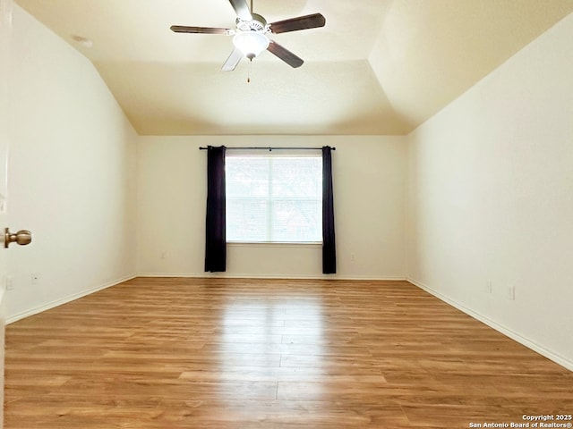 unfurnished room featuring lofted ceiling, light hardwood / wood-style floors, and ceiling fan