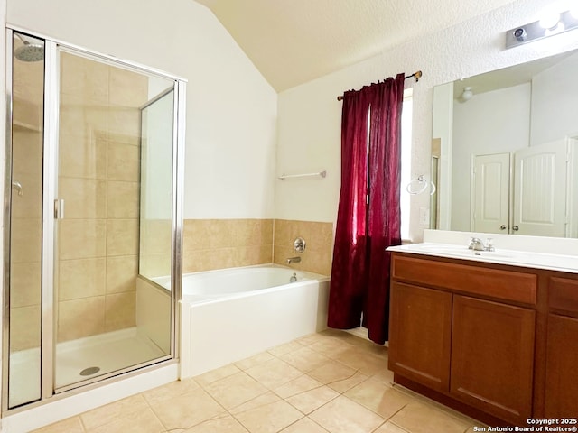 bathroom with tile patterned flooring, vaulted ceiling, separate shower and tub, and vanity