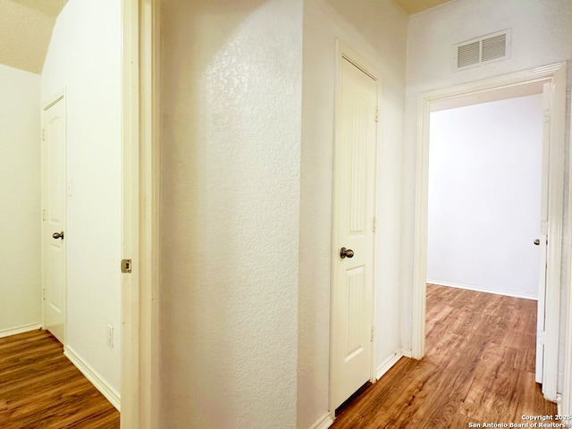 hall with hardwood / wood-style floors