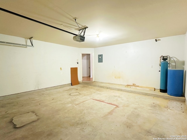 garage with a garage door opener and electric panel