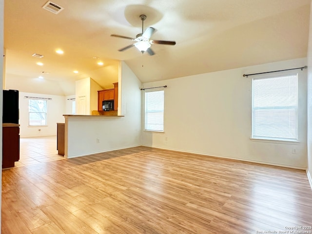 unfurnished living room featuring ceiling fan, lofted ceiling, and light wood-type flooring