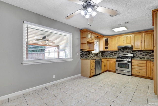 kitchen featuring appliances with stainless steel finishes, sink, ceiling fan, and decorative backsplash