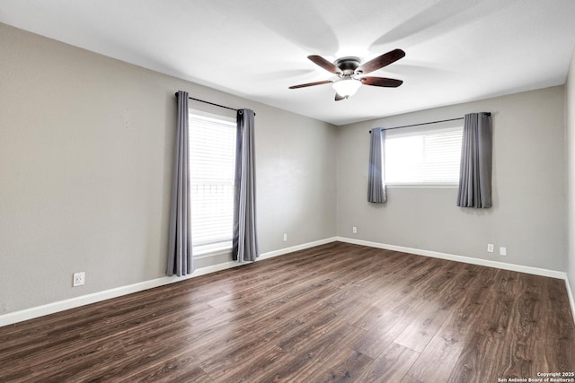 unfurnished room with dark hardwood / wood-style flooring and ceiling fan