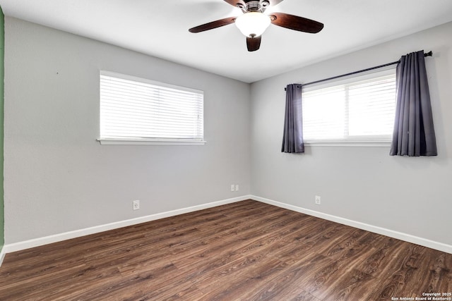 spare room featuring dark hardwood / wood-style flooring and ceiling fan