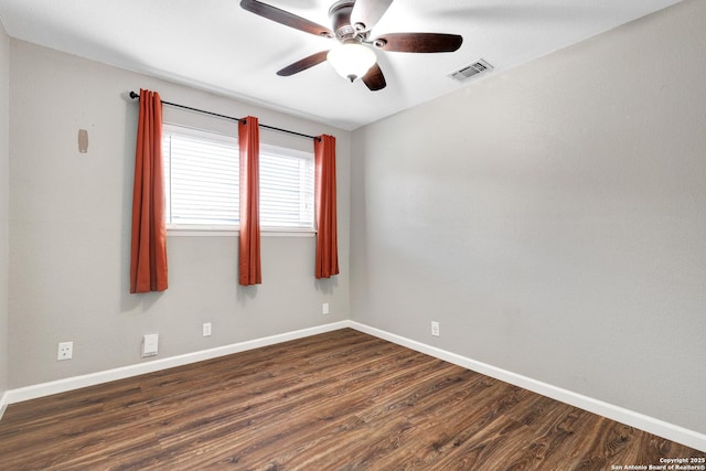 spare room featuring dark hardwood / wood-style floors and ceiling fan