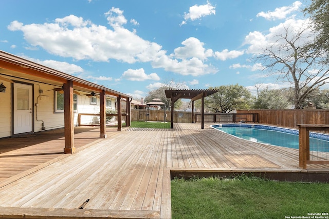 view of pool with a wooden deck and a pergola