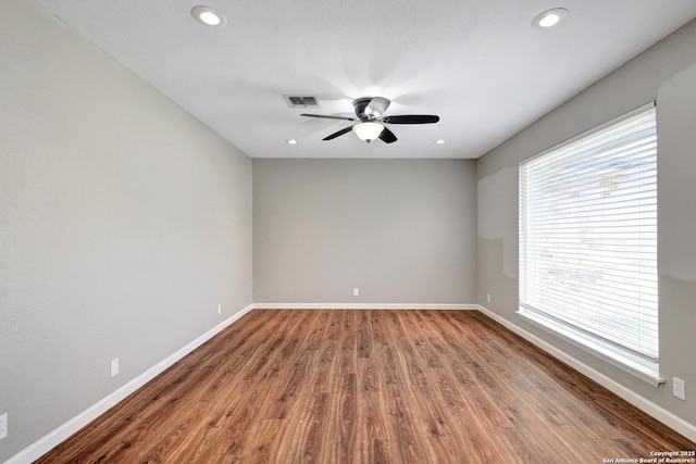 spare room featuring hardwood / wood-style flooring and ceiling fan