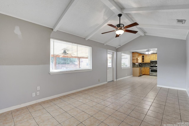 unfurnished living room with light tile patterned floors, lofted ceiling with beams, a textured ceiling, and ceiling fan