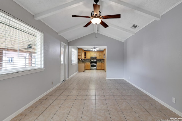 unfurnished living room with lofted ceiling with beams, light tile patterned flooring, ceiling fan, and a textured ceiling