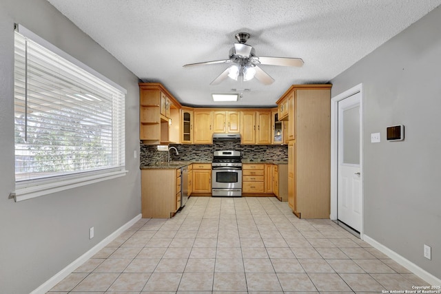 kitchen featuring stainless steel gas range, a textured ceiling, light tile patterned floors, ceiling fan, and decorative backsplash