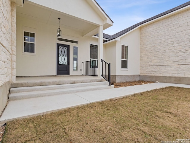 doorway to property featuring a lawn