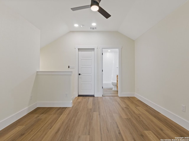 bonus room with lofted ceiling, light hardwood / wood-style floors, and ceiling fan