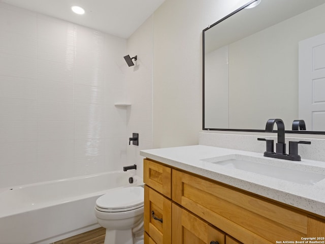 full bathroom featuring vanity, hardwood / wood-style floors, shower / bathtub combination, and toilet